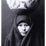 Zuni girl with a pottery jar on her head